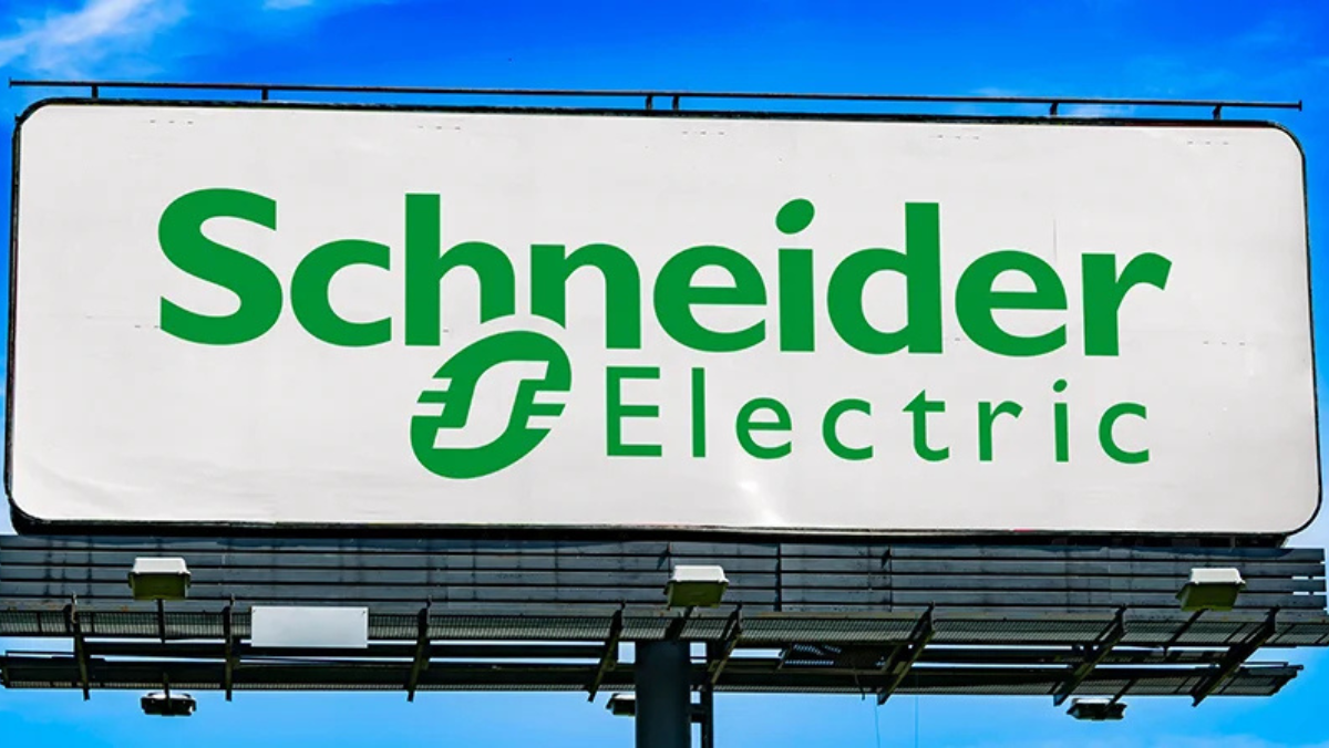 Schneider Electric logo displayed on a large outdoor billboard under blue sky